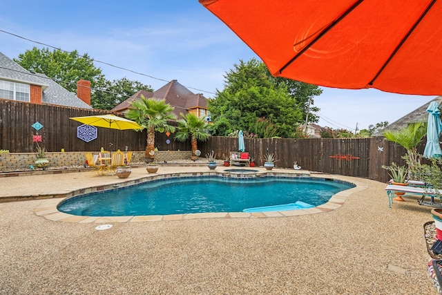 view of swimming pool with a patio area and an in ground hot tub