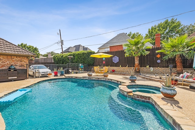 view of pool with an in ground hot tub, central AC unit, and a patio