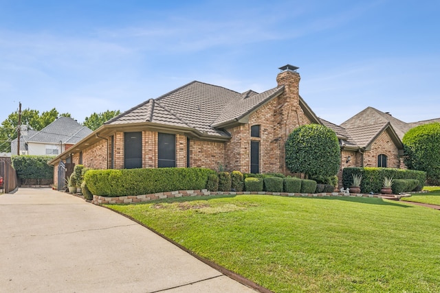 english style home with a front yard