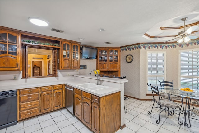 kitchen featuring sink, light tile patterned floors, stainless steel dishwasher, ceiling fan, and kitchen peninsula