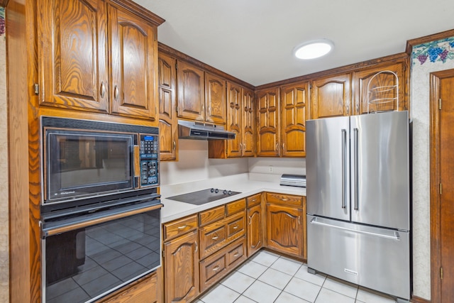 kitchen featuring light tile patterned floors and black appliances