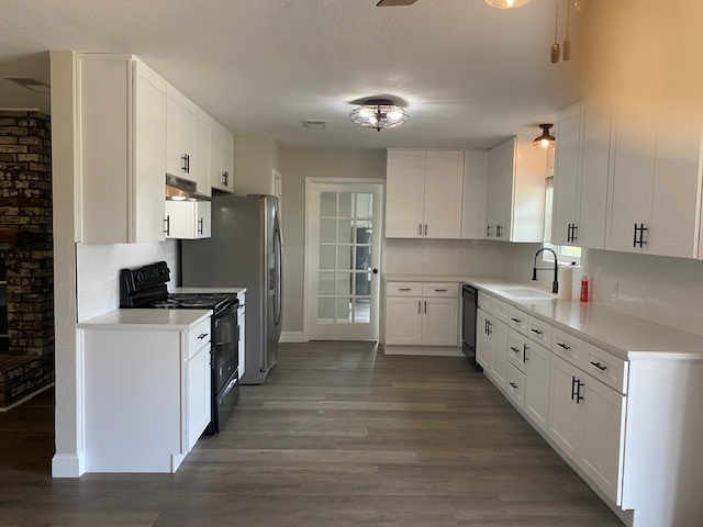 kitchen with white cabinetry, black appliances, sink, backsplash, and dark wood-type flooring