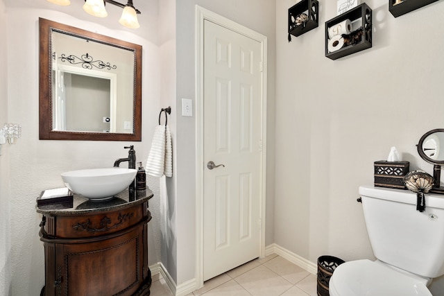 bathroom with vanity, tile patterned floors, and toilet