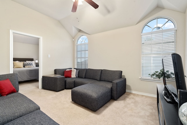 carpeted living room featuring plenty of natural light, ceiling fan, and vaulted ceiling