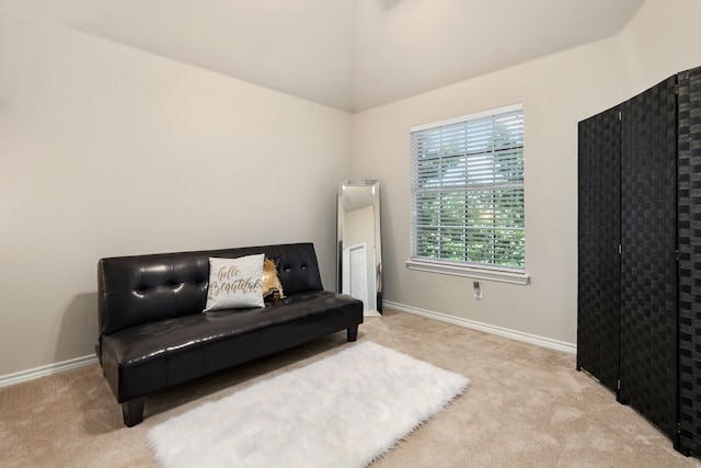 sitting room with light carpet and vaulted ceiling