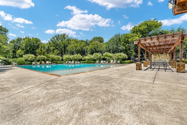 view of swimming pool with a pergola and a patio