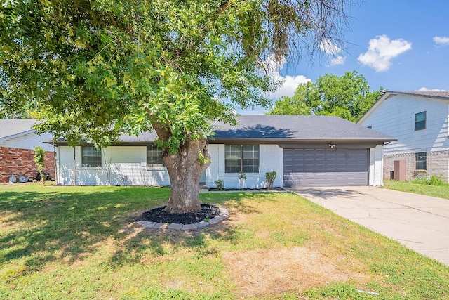 view of front of home with a garage and a front yard