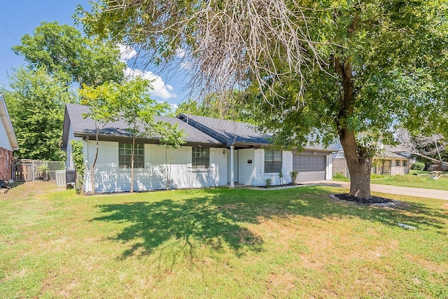 ranch-style house featuring a garage and a front yard