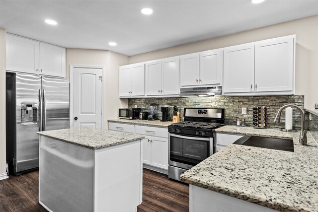 kitchen with white cabinetry, a center island, dark hardwood / wood-style flooring, stainless steel appliances, and sink