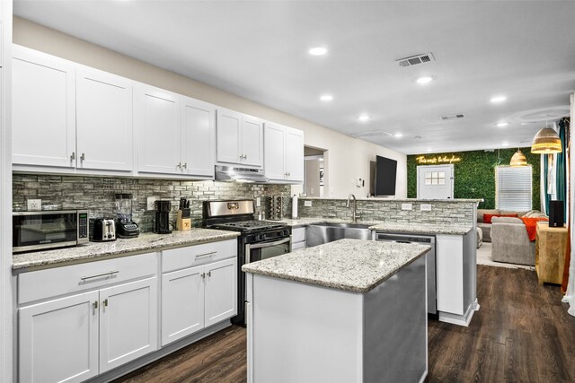 kitchen featuring a center island, dark hardwood / wood-style flooring, appliances with stainless steel finishes, and sink