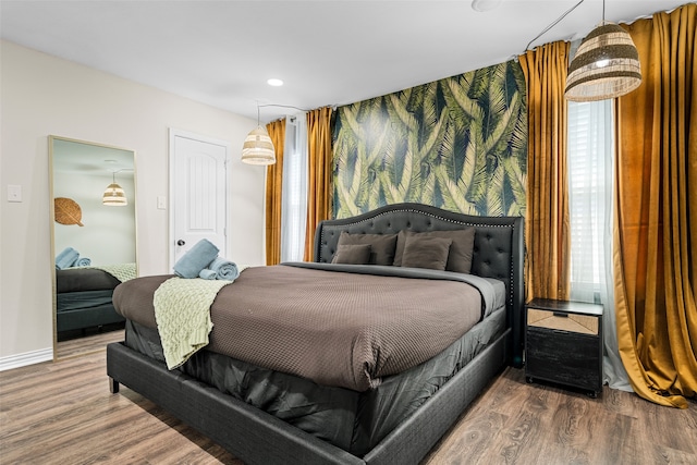 bedroom featuring multiple windows and hardwood / wood-style floors