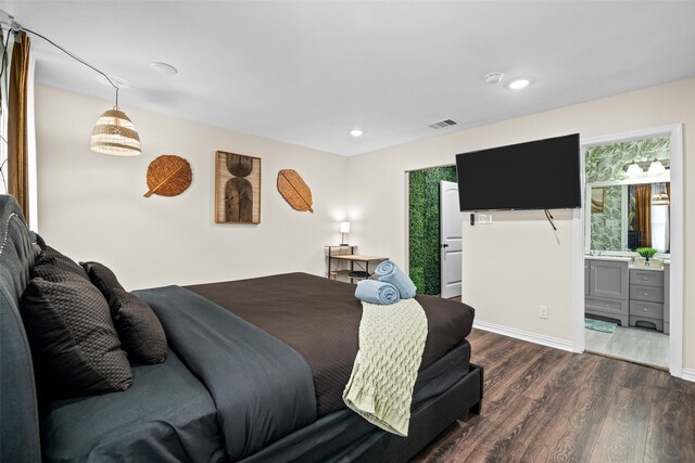 bedroom with dark hardwood / wood-style floors