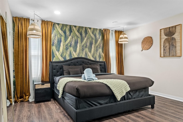 bedroom with dark hardwood / wood-style floors