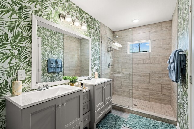 bathroom with a shower with door and double vanity