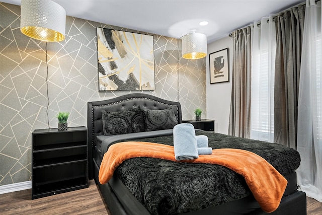 bedroom featuring wood-type flooring and tile walls