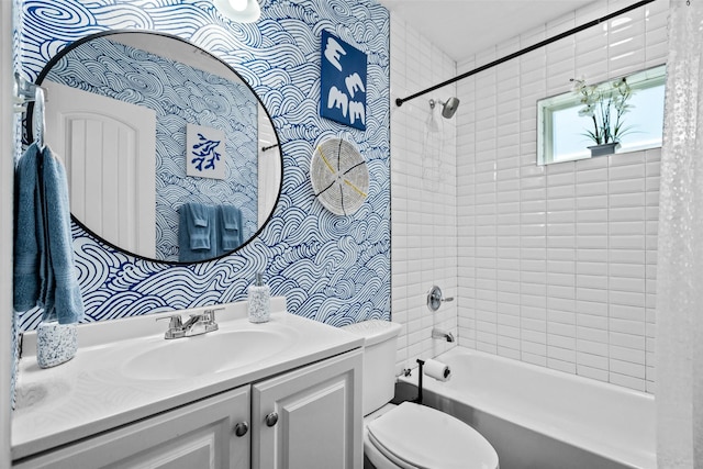 full bathroom with vanity, tiled shower / bath, and toilet