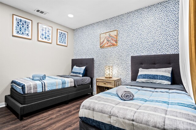 bedroom with dark wood-type flooring