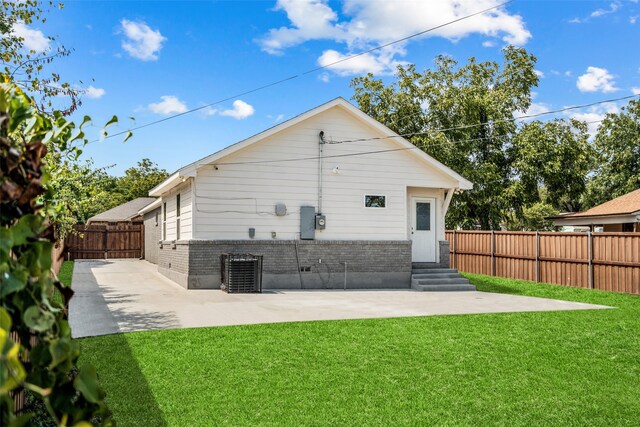 back of house with a patio area, central AC unit, and a yard