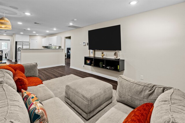 living room with dark hardwood / wood-style flooring