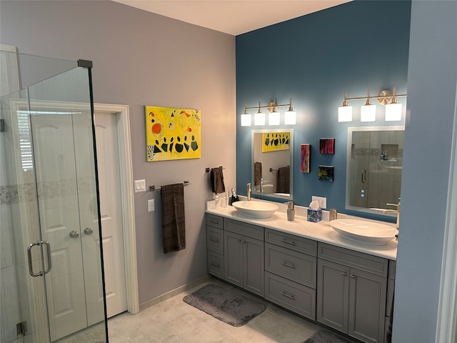 bathroom with a shower with shower door, tile patterned floors, and double vanity