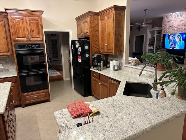 kitchen with decorative backsplash, ceiling fan, black appliances, light tile patterned floors, and sink