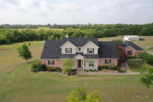 cape cod home with a front yard