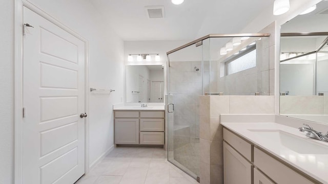 bathroom with tile patterned flooring, vanity, and a shower with door