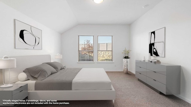 carpeted bedroom with lofted ceiling