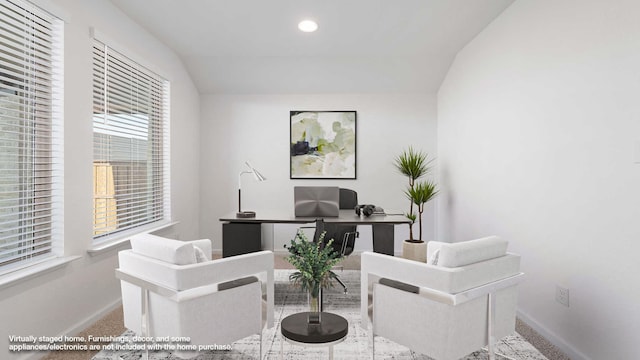 office area featuring carpet floors and vaulted ceiling