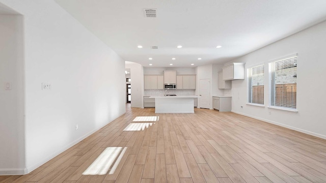 unfurnished living room featuring light wood-type flooring