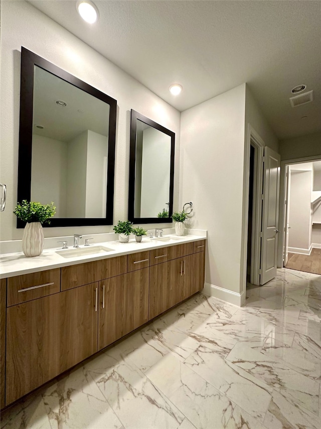 bathroom with vanity and a textured ceiling