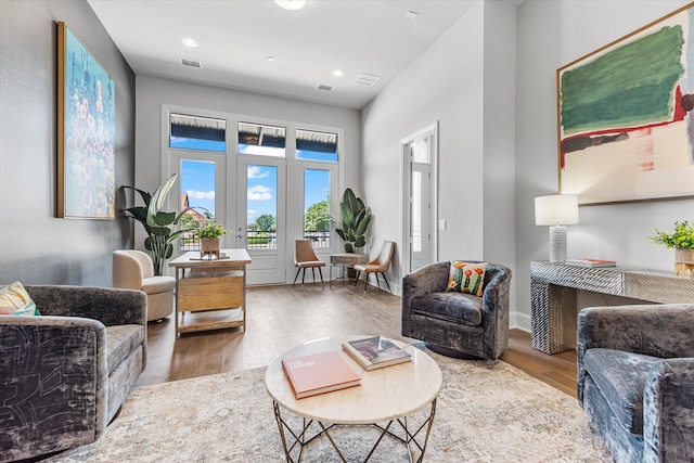 living room featuring wood-type flooring and french doors