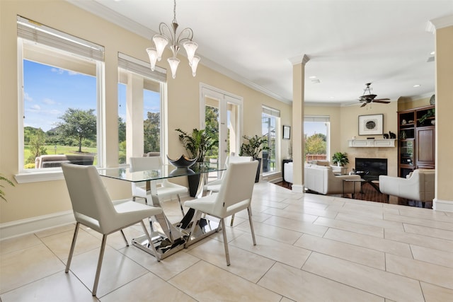 dining area featuring ceiling fan with notable chandelier, a wealth of natural light, and ornamental molding