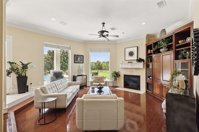 living room featuring dark hardwood / wood-style floors, crown molding, and ceiling fan