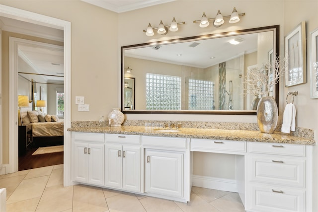 bathroom with vanity, crown molding, walk in shower, and tile patterned flooring