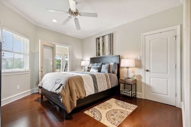 bedroom with ornamental molding, ceiling fan, and dark wood-type flooring