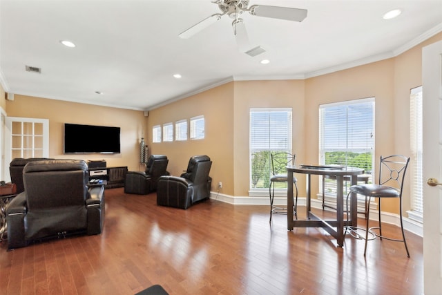 living room featuring ceiling fan, hardwood / wood-style flooring, and ornamental molding