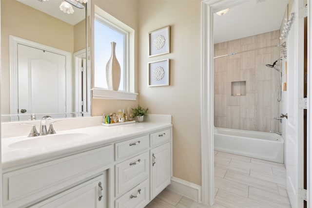 bathroom with vanity, tile patterned flooring, and tiled shower / bath