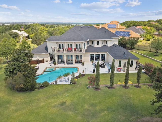 649 Oak Tree Cv, Cedar Hill, TX 75104 - rear view of house featuring a balcony, a shingled roof, a pool with connected hot tub, a patio, and stucco siding