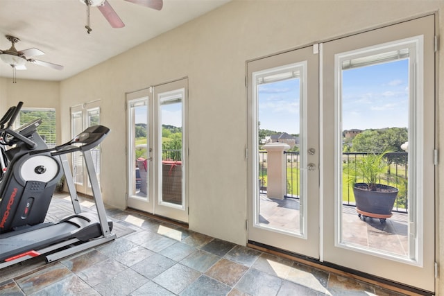 workout area with tile patterned floors, a wealth of natural light, and ceiling fan