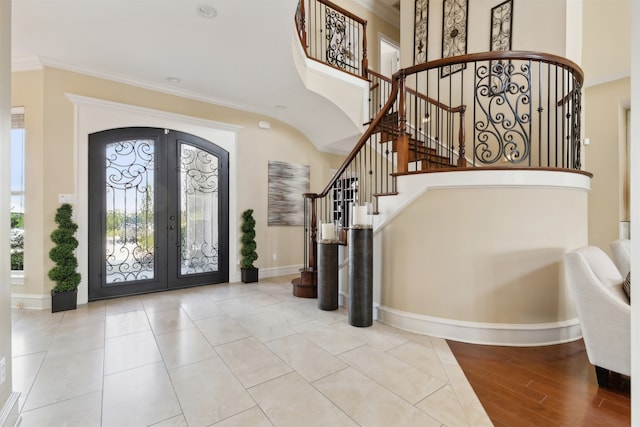 foyer entrance featuring french doors, wood-type flooring, and ornamental molding