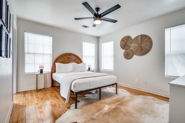 bedroom with light hardwood / wood-style flooring and ceiling fan