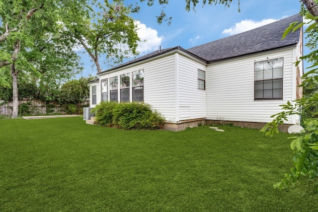 view of side of home with a lawn