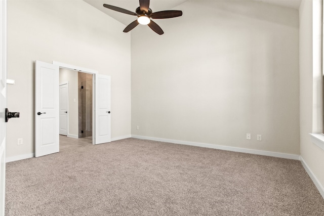 unfurnished bedroom with ceiling fan, high vaulted ceiling, and light carpet