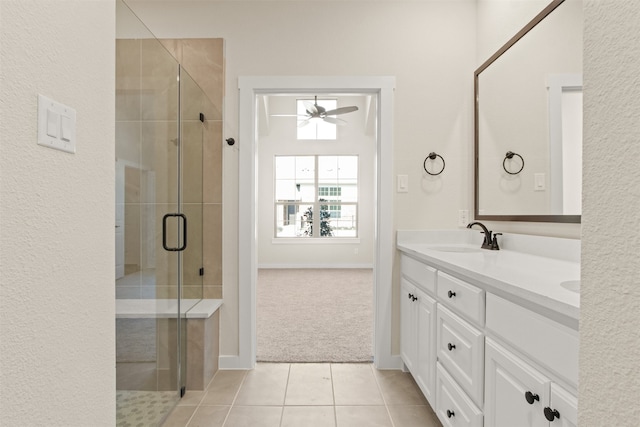 bathroom with ceiling fan, vanity, an enclosed shower, and tile patterned flooring