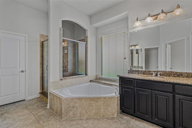 bathroom featuring vanity, shower with separate bathtub, and tile patterned flooring