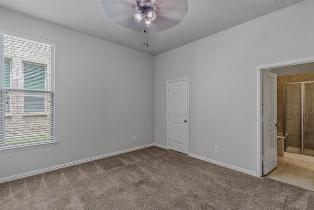 carpeted spare room featuring ceiling fan