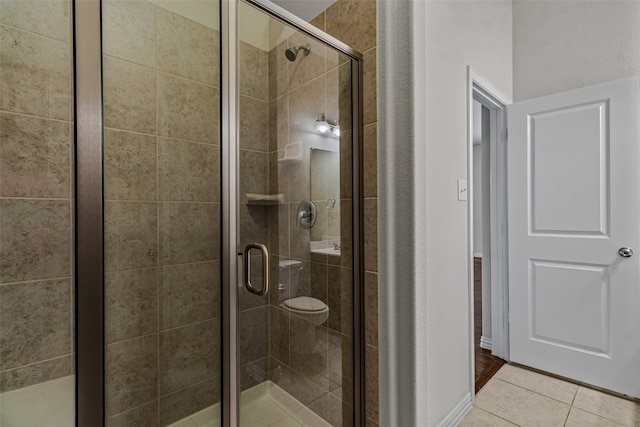 bathroom with walk in shower and tile patterned flooring