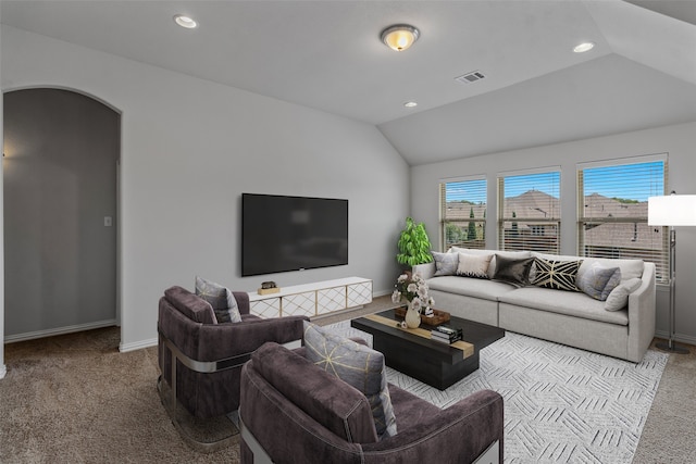 carpeted living room featuring vaulted ceiling