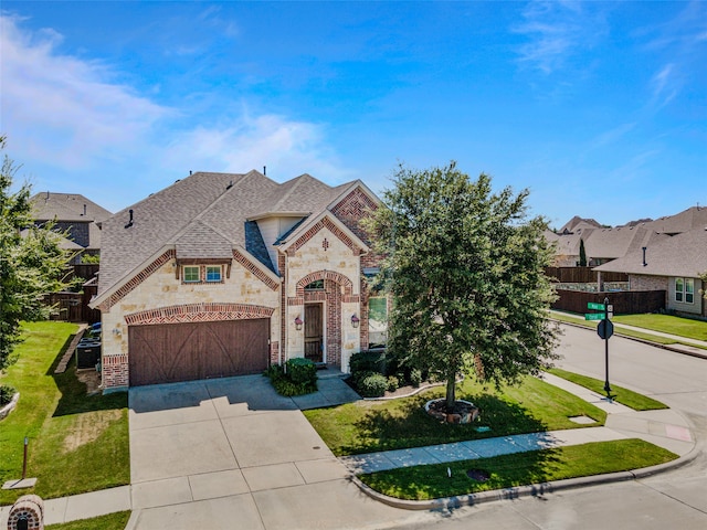 view of front of property featuring a garage and a front lawn